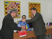 Памятный подарок с символикой БелГУ вручается директору шахматного клуба Г.С. Кикневу